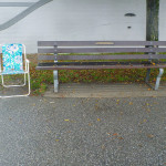 Bench and folding chair in the rain